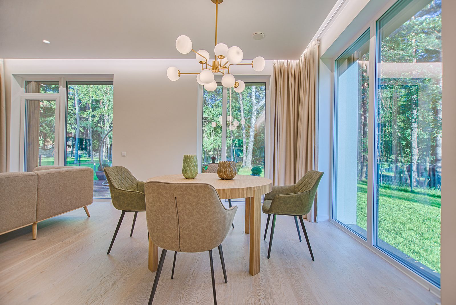 A bright dining area with a table beside large windows