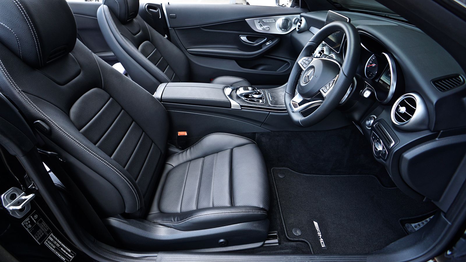 The front seats and dashboard of a parked car