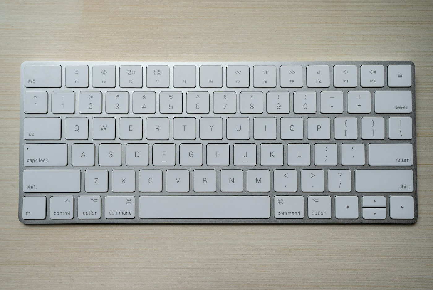 A low-profile keyboard on a wooden desktop