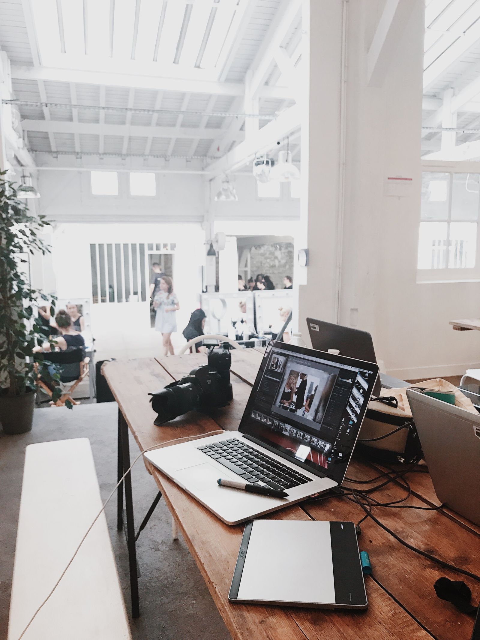 A laptop and computer equipment on a bright creative workspace desk