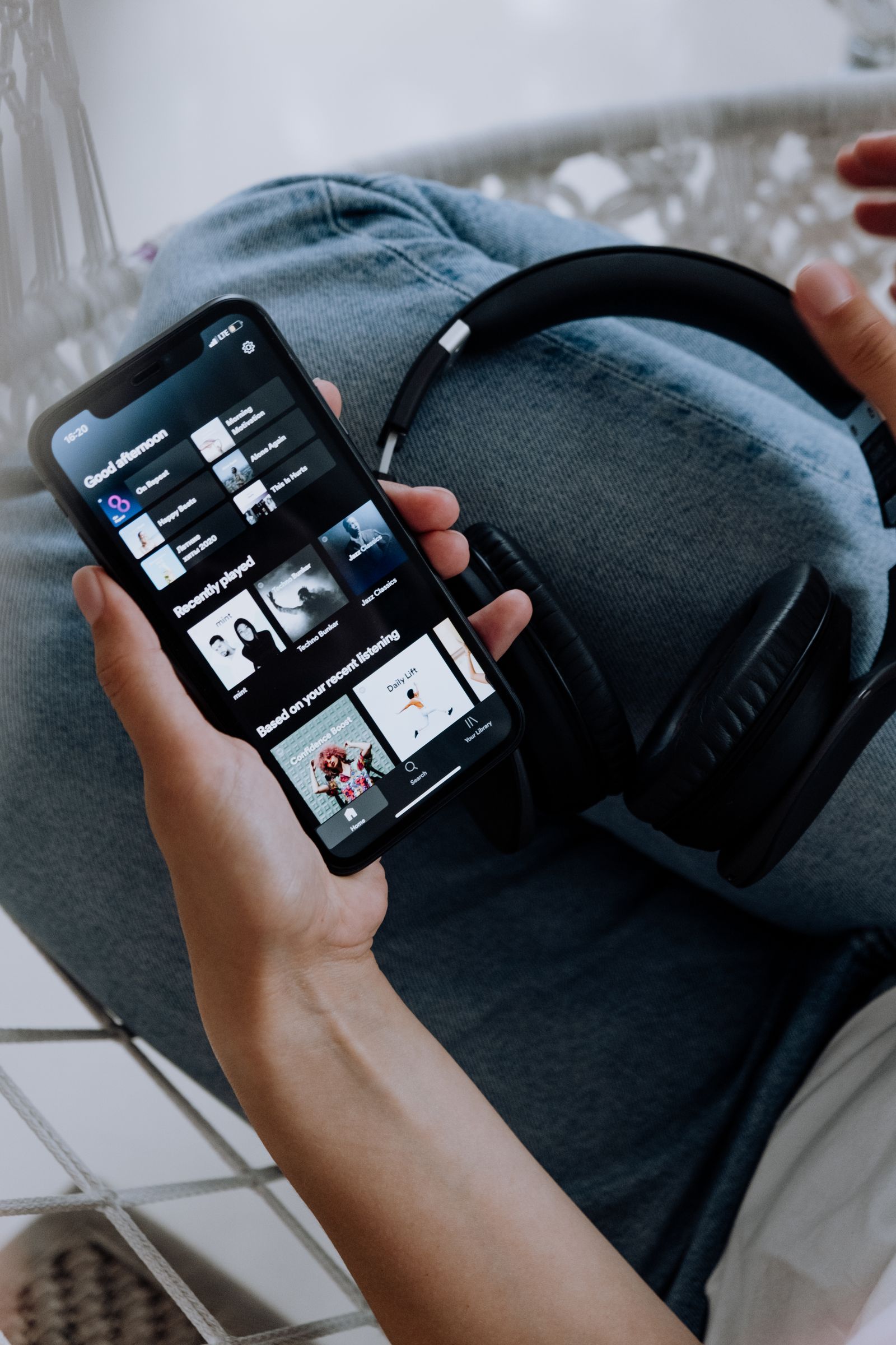 A person browsing content on a smartphone while seated at home